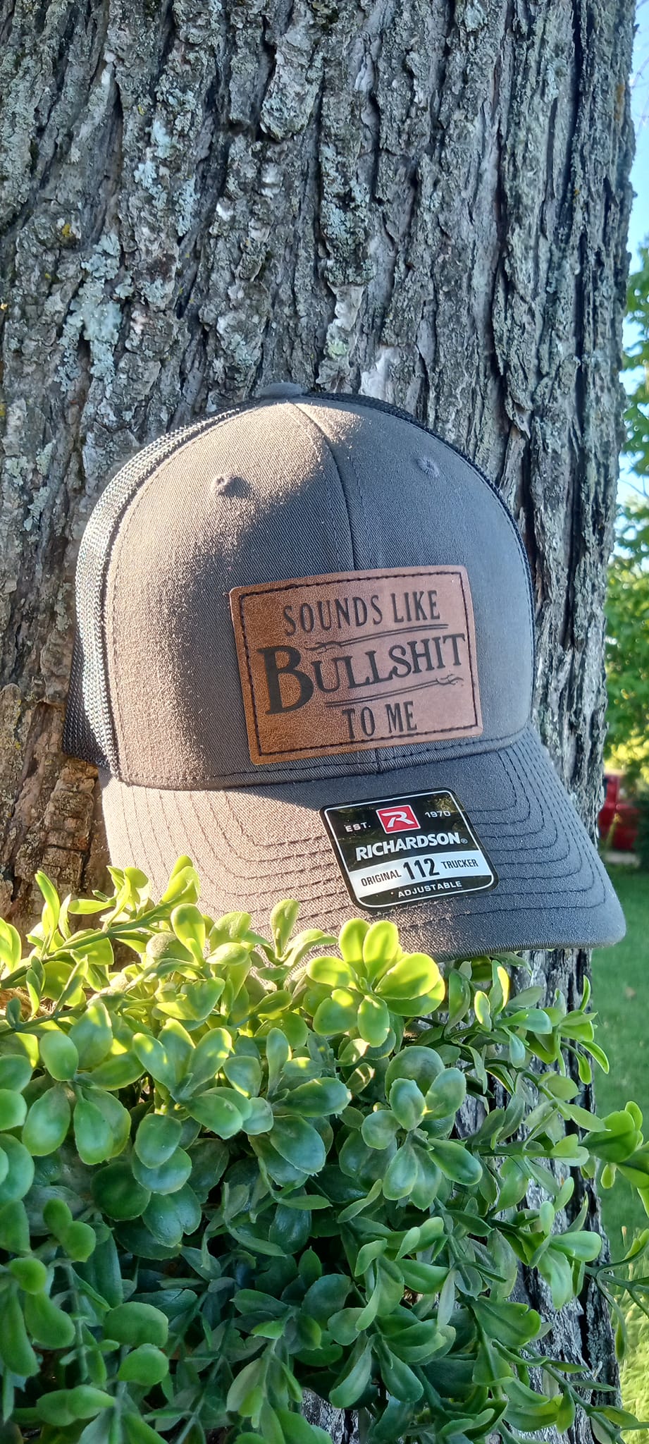 Sounds like Bs to me Leather patch hat gray and black with laser engraved hat patch